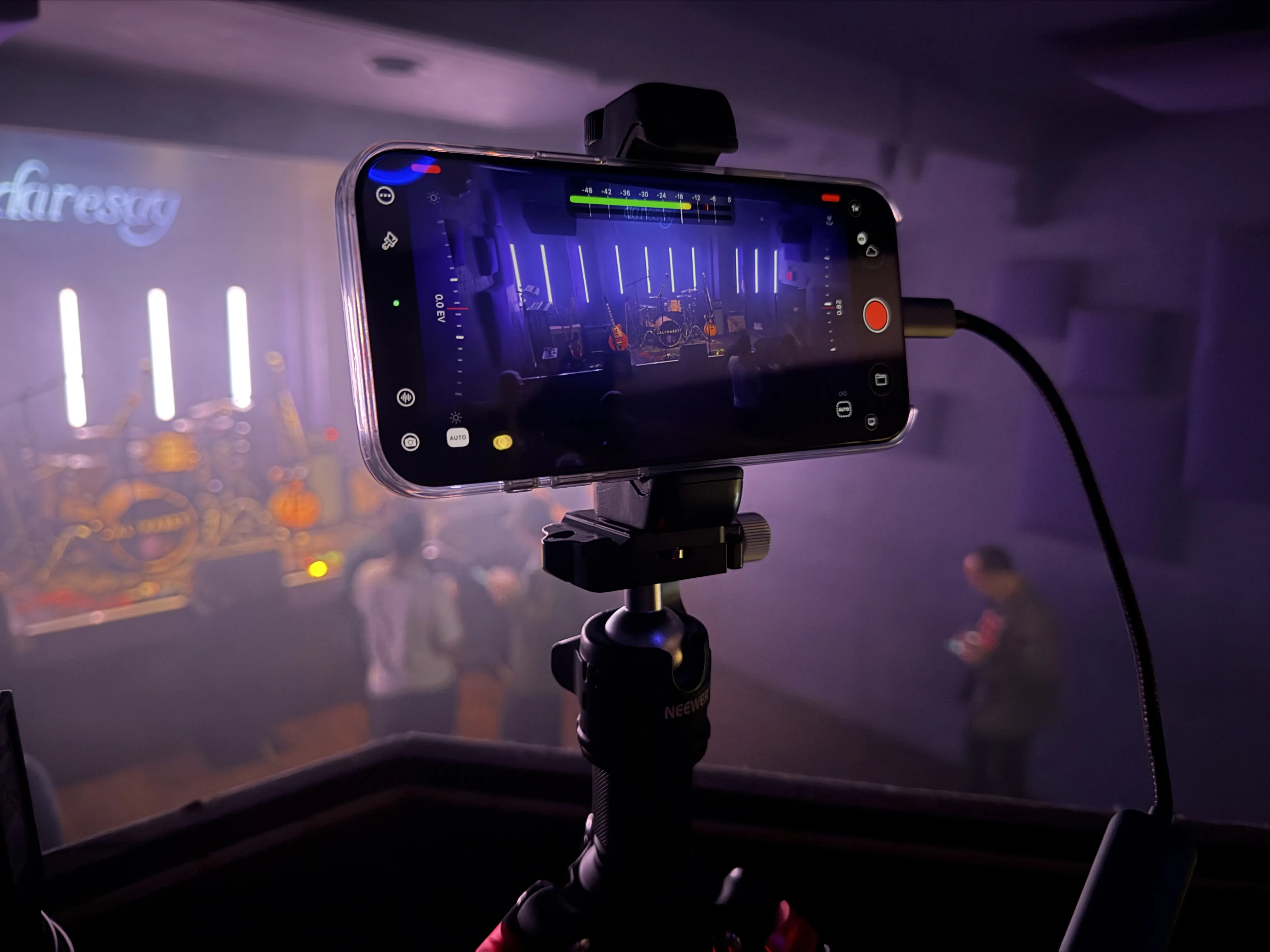 iPhone running Mavis Camera records a live music stage
