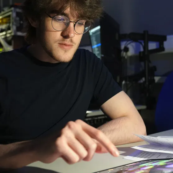 A student operating Mavis Studio on an iPad in a production studio